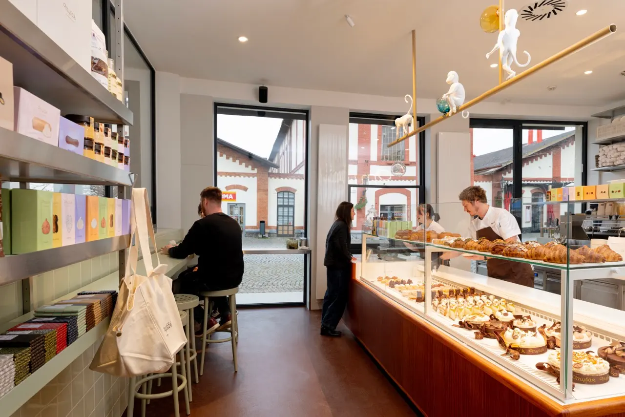 Interior of Myšák patisserie at Holešovice Market with dessert display.